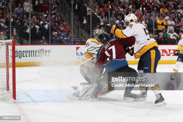Tyson Jost of the Colorado Avalanche is pushed by goaltender Pekka Rinne and Roman Josi of the Nashville Predators in Game Four of the Western...