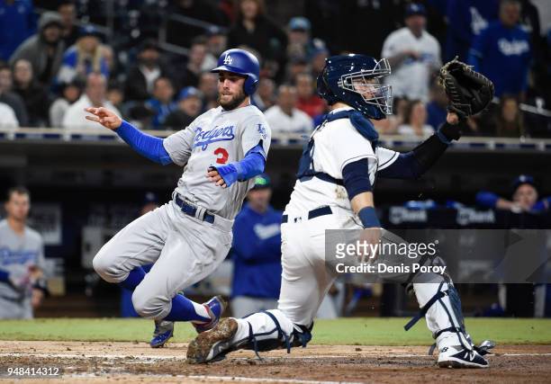 Chris Taylor of the Los Angeles Dodgers scores ahead of the throw to Austin Hedges of the San Diego Padres during the eighth inning of a baseball...
