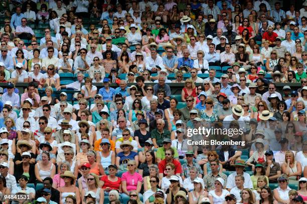 Spectators watch the action in the match between Rafael Nadal of Spain and Andreas Beck of Germany at the Wimbledon tennis championships in southwest...