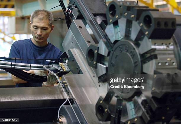 An employee works on the production line manufacturing construction equipment at Doosan Infracore Co.'s plant in Changwon, South Korea, on Friday,...