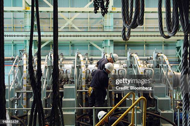 Employees work on the production line manufacturing ship engines at Doosan Engine Co.'s plant in Changwon, South Korea, on Friday, Sept. 26, 2008....