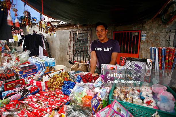 Sonny del Pilar works at stall outside his home in the Batasan Hills, in Quezon City, the Philippines, on Saturday, Dec. 6, 2008. Del Pilar tried for...