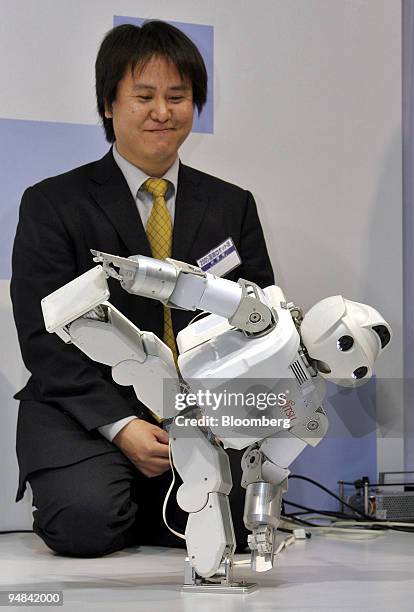 Fujitsu Ltd. HOAP-3 robot is put through its paces by a controller at the International Robot Exhibition in Tokyo, Wednesday, November 30, 2005. The...