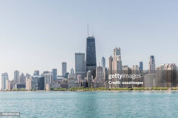 chicago skyline with lake michigan against clear sky,illinois - chicago skyline stock pictures, royalty-free photos & images