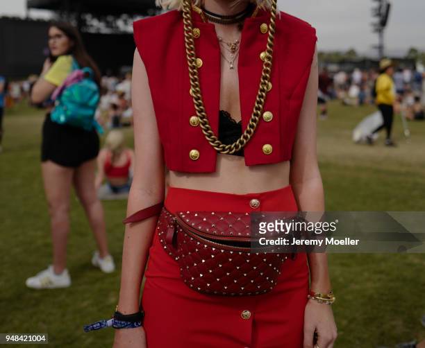 Coachella guest wearing a Maison Valentino belt bag and Givenchy boots during day 3 of the 2018 Coachella Valley Music & Arts Festival Weekend 1 on...