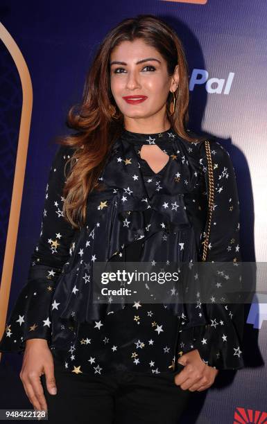 Indian Bollywood actress Raveena Tandon attends the Disneys Aladdin Broadway-style musical show in Mumbai on April 18, 2018. / AFP PHOTO / -