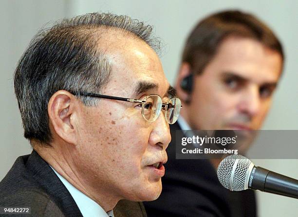 Mitsubishi Fuso Truck & Bus Corp.'s new chairman Michio Hori, left, speaks to reporters as chief executive and President Wildfried Porth listens at a...