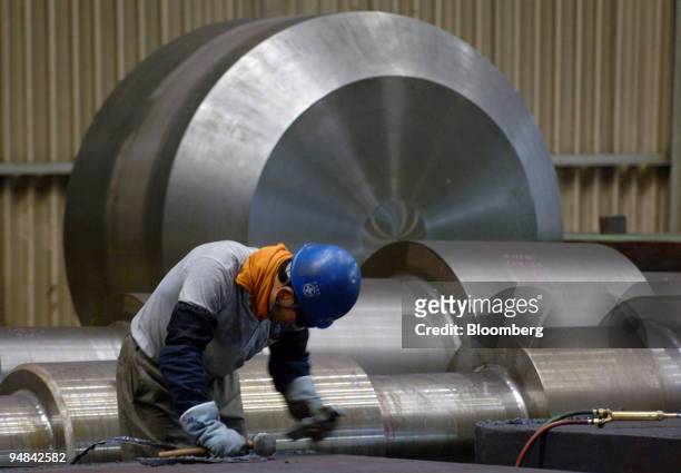 An employee works on a turbine for a generator plant at Doosan Heavy Industries & Construction Co.'s Changwon plant in Changwon, South Korea, on...
