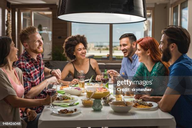 large group of happy friends having fun while talking on a dinner party. - large dinner party stock pictures, royalty-free photos & images