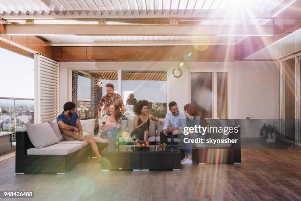 young happy friends talking on a penthouse patio. - apartment building exterior imagens e fotografias de stock