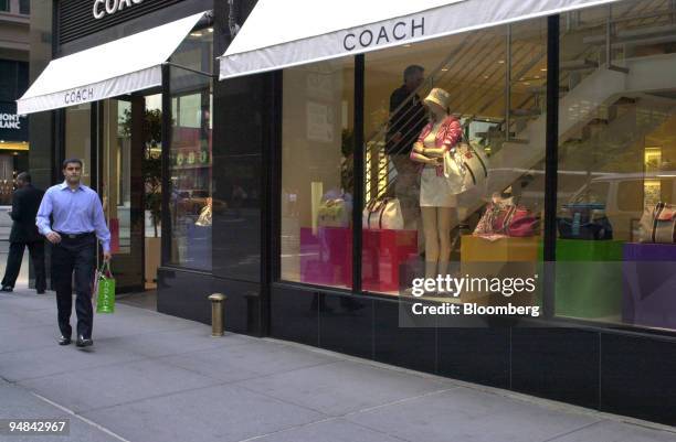 Man leaves a Coach Inc. Store in New York on Tuesday, April 20, 2004. Coach Inc., the largest U.S. Seller of luxury leather goods, said third-quarter...