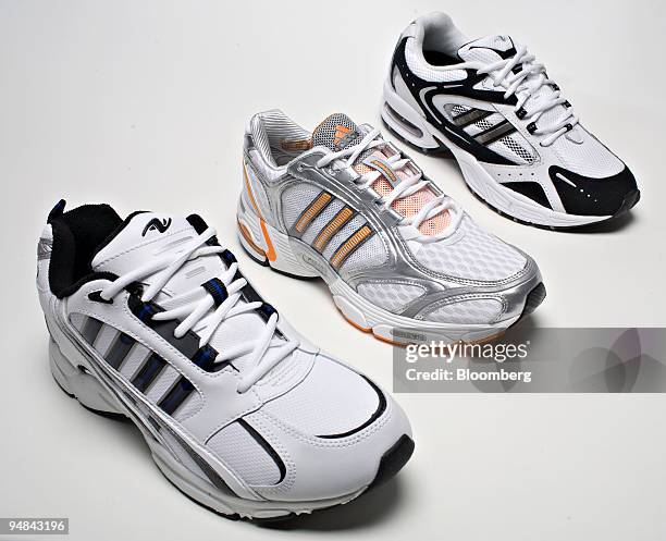 An Adidas adiFusion MC sneaker, center, is arranged for a photograph with a Wal-Mart Stores Athletic Works brand Carson sneaker bearing two-stripes,...