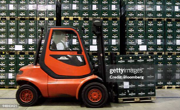 Worker uses a forklift to move cases of beer at the Holsten Brewery in Hamburg, Germany, Monday, November 28, 2005. Holsten Brauerei AG was bought...