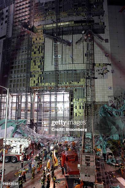 Rescue workers and fire fighters remove rubble where scaffolding collapsed during repair work at a LG Department Store in Bucheon, Korea, near Seoul,...