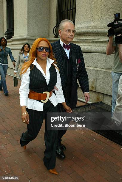 Kimberly Jones, best known as rapper Lil' Kim, escorted by her lawyer, Mel Sachs,as she enters Federal Court in New York April 19, 2004. She is...