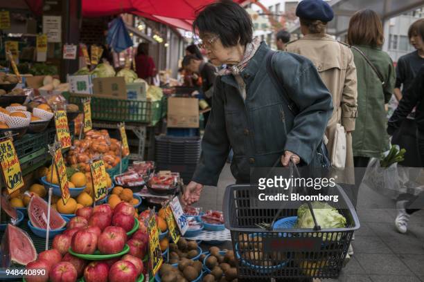 Woman shops at a fruit stall in the Koenji neighborhood in Tokyo, Japan, on Saturday, April 14, 2018. Japan's headline inflation measure is expected...
