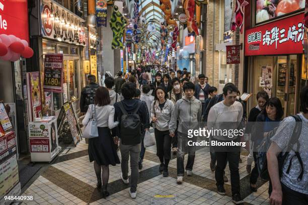 People walk through a shopping arcade in the Nakano District of Tokyo, Japan, on Saturday, April 14, 2018. Japan's headline inflation measure is...