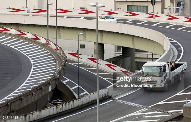 Mitsubishi Fuso truck drives on an overpass near the Tokyo Stock Exchange on Friday, January 28, 2005. DaimlerChrysler AG, the world's largest...