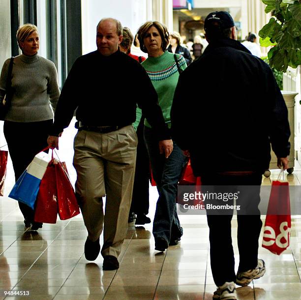 Shoppers carry bags inside the Lenox Mall Atlanta, Georgia, Friday, November 25, 2005.
