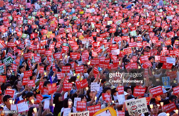 People participate in a candlelight vigil to protest against U.S. Beef imports in Seoul, South Korea, on Saturday, May 31, 2008. South Korean...