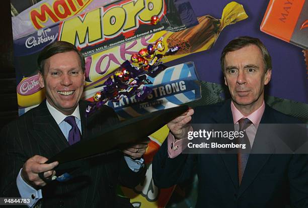 Todd Stitzer, chief executive officer, left, and Ken Hanna chief financial officer of Cadbury Schweppes Plc. Toss chocolate eggs into the air at a...