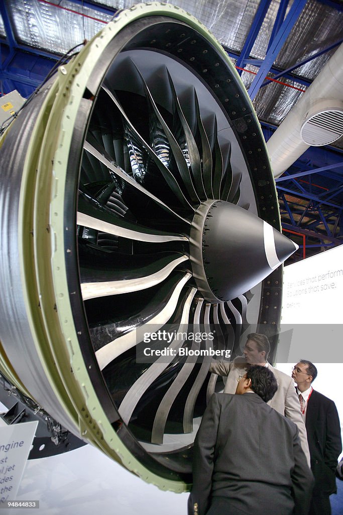 Visitors to the Asian Aerospace 2006 show inspect General El