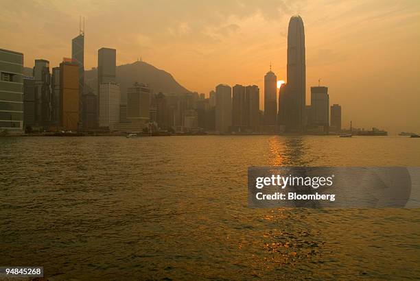 The sun sets over Hong Kong's Victoria Harbour and the area of water where a proposed land reclamation project will take place, pictured from the...