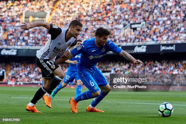Cabrera of Getafe CF competes for the ball with Andreas Pereira of Valencia CF during the La Liga game between Valencia CF and Getafe CF at Mestalla...