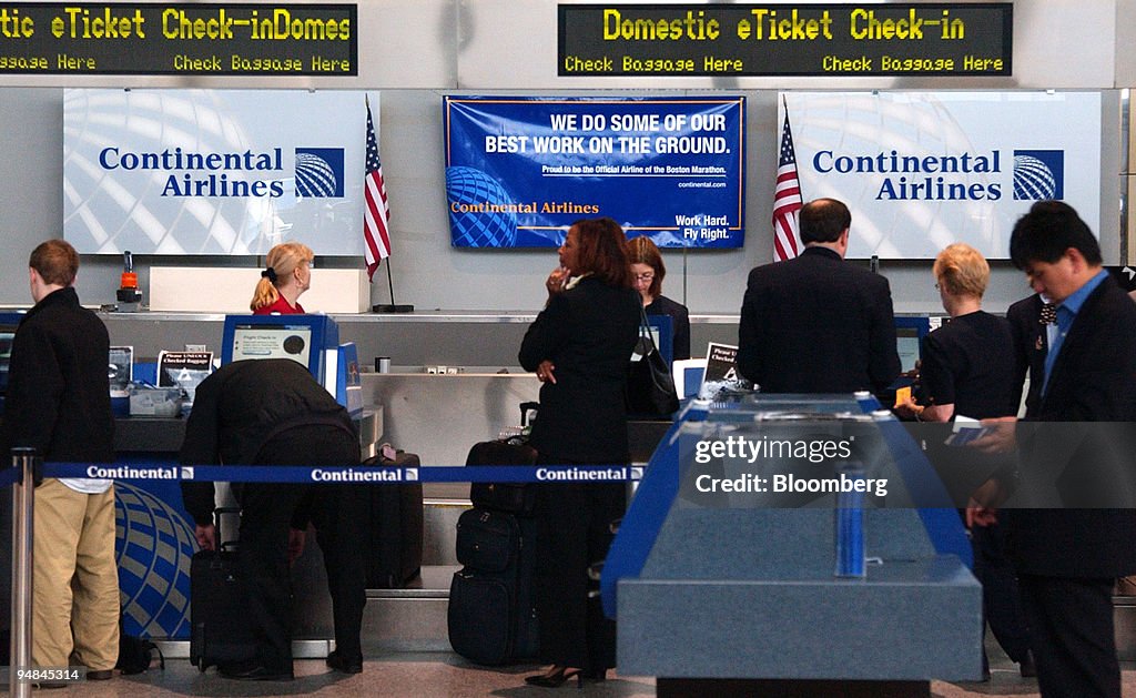 Passengers check in at the Continental Airlines counter at L