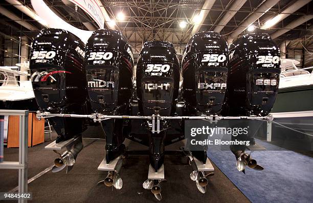 Five outboard motors hang from the back of a Midnight Express boat on display at the New York National Boat Show in New York, U.S., on Dec. 18, 2008.