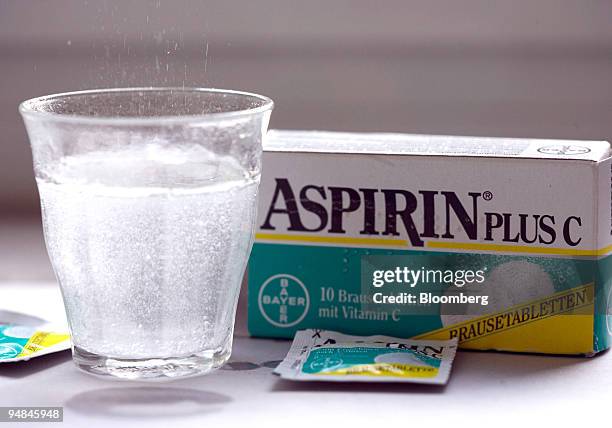 Bayer aspirin tablets dissolve in a glass in Bonn, Germany, on Wednesday, Sept. 17, 2008. Speculation continues that Pfizer Inc. Will bid for the...