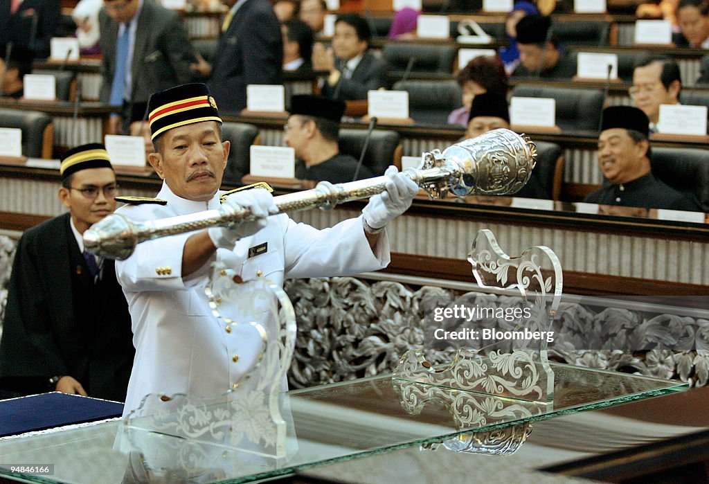An official handles the mace at the swearing-in ceremony of