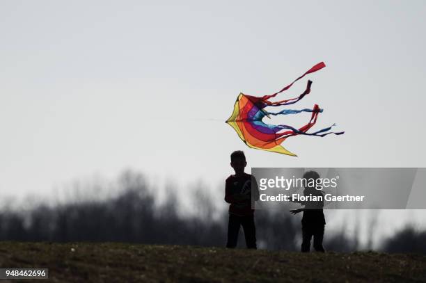 Two children have a colorful kite go up on the Drachenberg in Berlin on April 08, 2018 in Berlin, Germany. The Teufelsberg or Drachenberg is a hill...