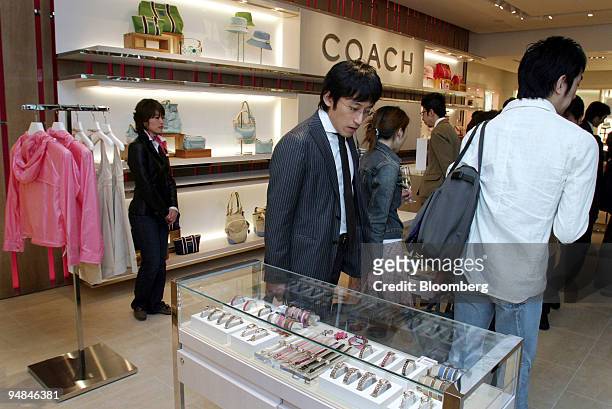 Guests look around Coach Inc.'s new shop in Tokyo's Marunouchi district Thursday, April 15, 2004. Japanese retail sales fell in April for the second...