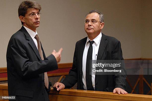 Jacob " Kobi'' Alexander, the former Comverse Technology Inc. Chief executive officer, right, confers with his lawyer, Louis du Pisani, while waiting...