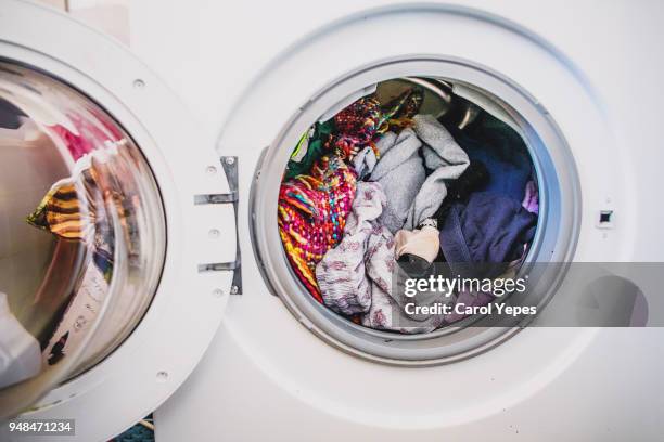 laundry day.washing machine full of colorful clothes - lavadora fotografías e imágenes de stock