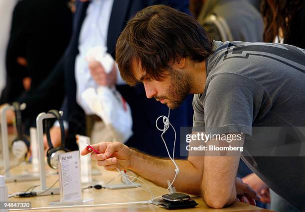 Luiz Pinho tests out an iPod Nano at an Apple store in New York, U.S., on Friday, Sept. 12, 2008. This week, Apple Inc. Chief Executive Officer Steve...