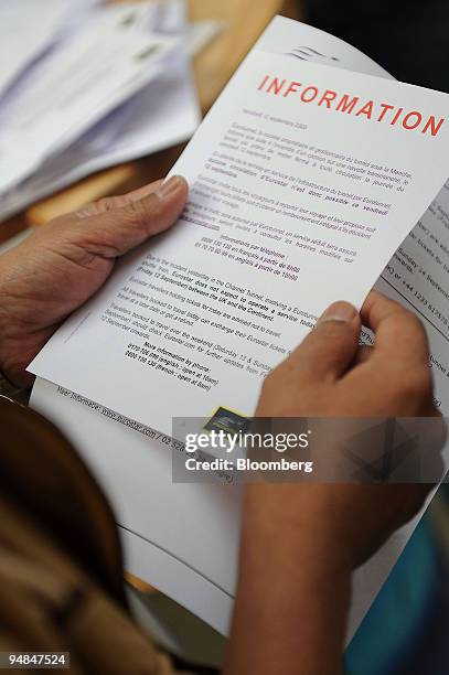 Passenger reads a paper announcing canceled Eurostar trains at the Gare du Nord train station in Paris, France, on Friday, Sept. 12, 2008. The...