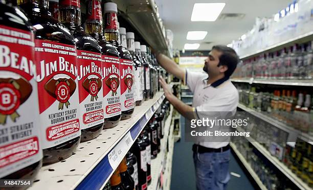 Viren Patel, an employee of Sharon Square Carry Out straightens the shelves Thursday, February 16 in Worthington, Ohio. Prominently displayed are...
