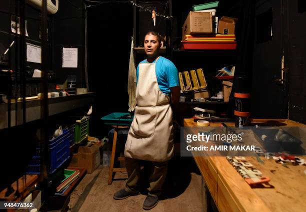 Mohamed el-Maymony, a 38-year-old Egyptian darkroom technician poses for a picture at a darkroom in downtown Cairo on April 4, 2018. - El-Maymony,...