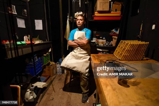 Mohamed el-Maymony, a 38-year-old Egyptian darkroom technician poses for a picture at a darkroom in downtown Cairo on April 4, 2018. - El-Maymony,...