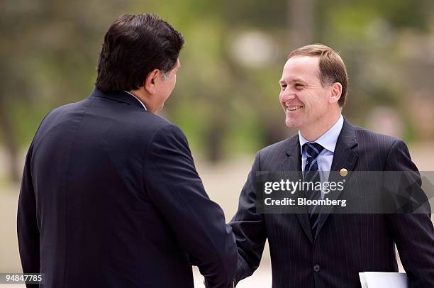 John Key, New Zealand?s prime minister, right, greets Alan Garcia, Peru?s president, at the Asia-Pacific Economic Cooperation meeting in Lima, Peru,...