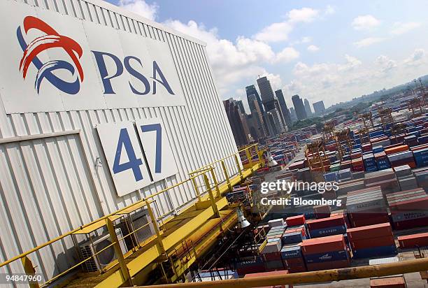 Shipping containers sit stacked in PSA Corp.'s Tanjong Pagar Container Terminal port near Singapore's downtown skyline on Tuesday, April 13, 2004....