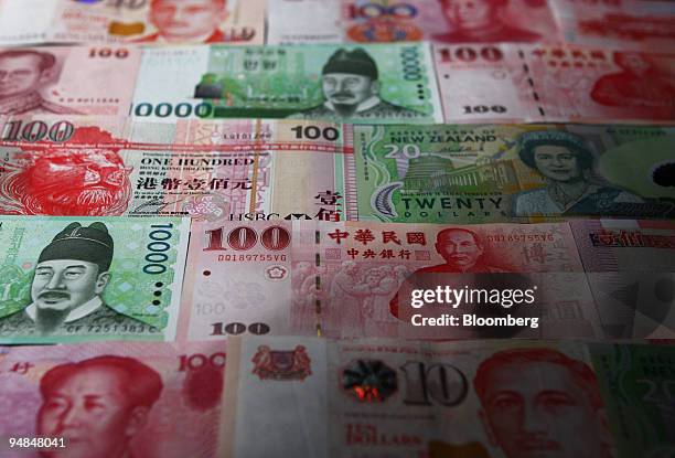 Asian currencies are arranged for a photograph in Tokyo, Japan, on Thursday, April 24. 2008. Asian currencies are 25 percent undervalued against the...