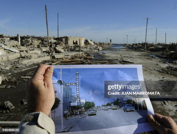 By Oscar Laski A man compares a picture of Lago Epecuen village taken in the 70's with the current state of the place -- flooded for almost 25 years...