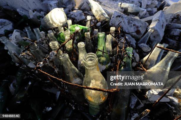 By Oscar Laski Picture of bottles in a rusty box taken at Lago Epecuen village, some 600 km southwest of Buenos Aires, on May 3, 2011 after the place...