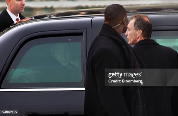 Security surrounds the new presidential limousine, a Cadillac by General Motors, as U.S. President George W. Bush, looks out the window at the US...