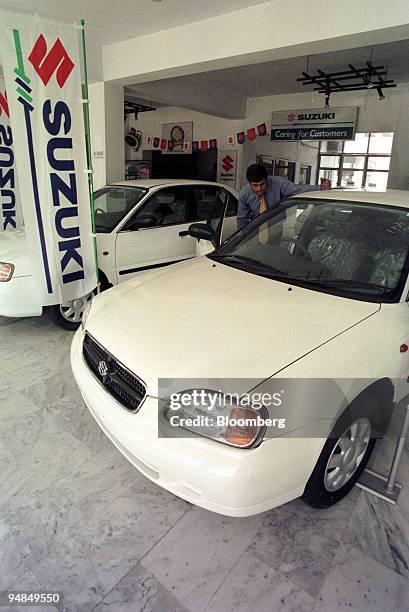 Customer inspects a car at Pakistan Suzuki Motors, a Suzuki Mehran in Islamabad, Pakistan on April 9, 2004. Shares of Pak Suzuki Motor Co. And Indus...