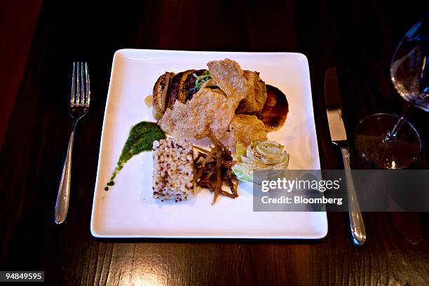 Plate of Peking-style snow-dried tofu with rice, quinoa, Chinese cabbage, burdock root and red miso hoisin is arranged for a photo at Broadway East,...