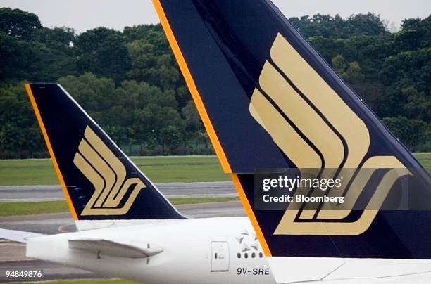 One Singapore Airlines Ltd. Jet moves past another on the runway at Changi airport in Singapore, on Thursday, Nov. 6, 2008. Singapore Airlines Ltd. ,...